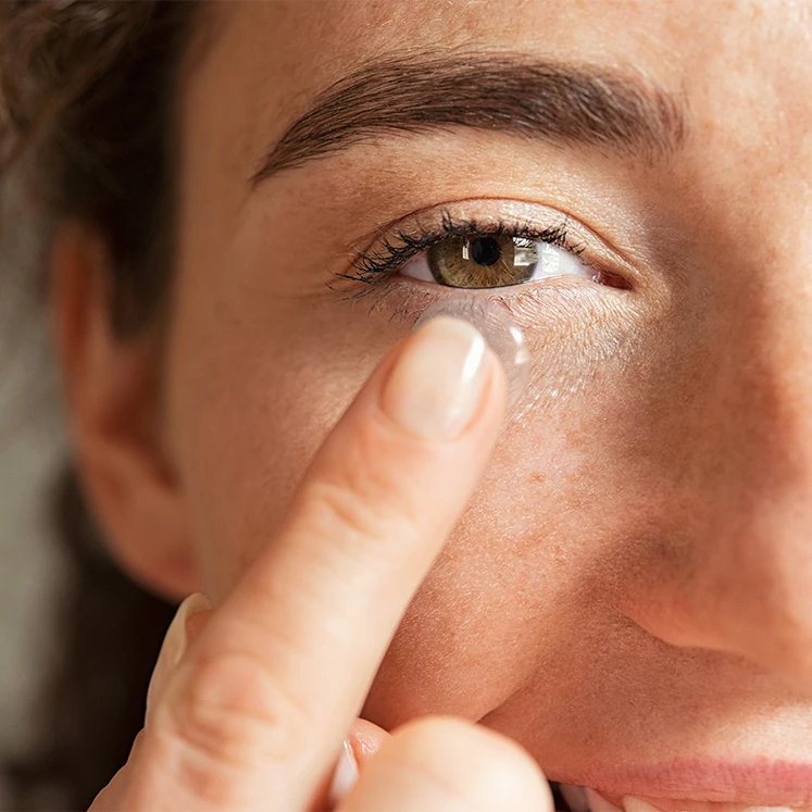 close up of woman inserting contact lens