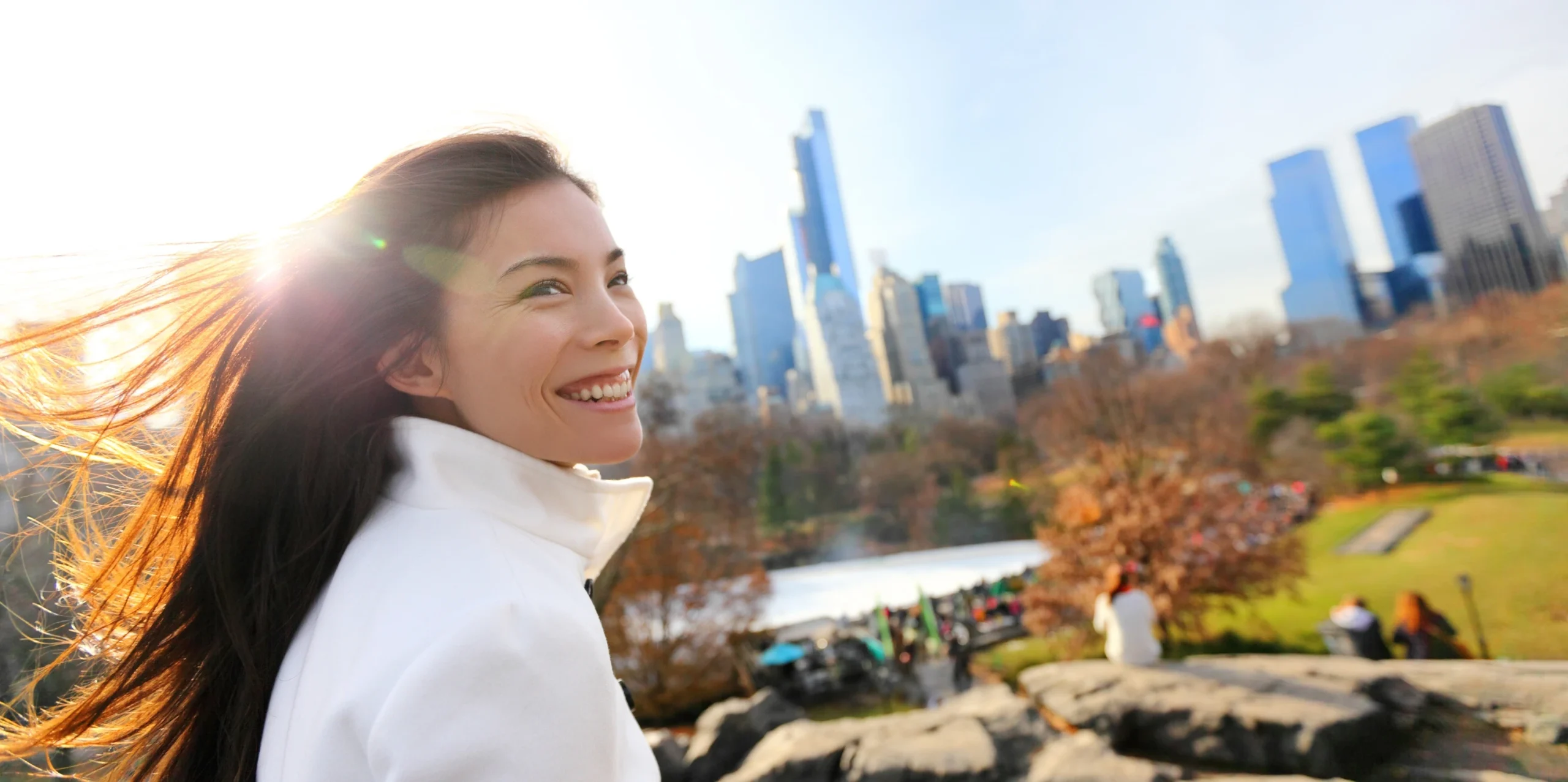 young healthy woman looking out over central park without glasses