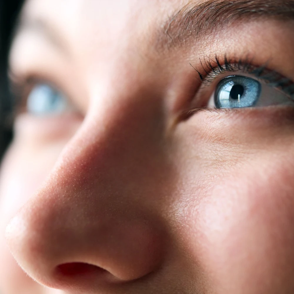 close up of woman's face and bright blue eyes