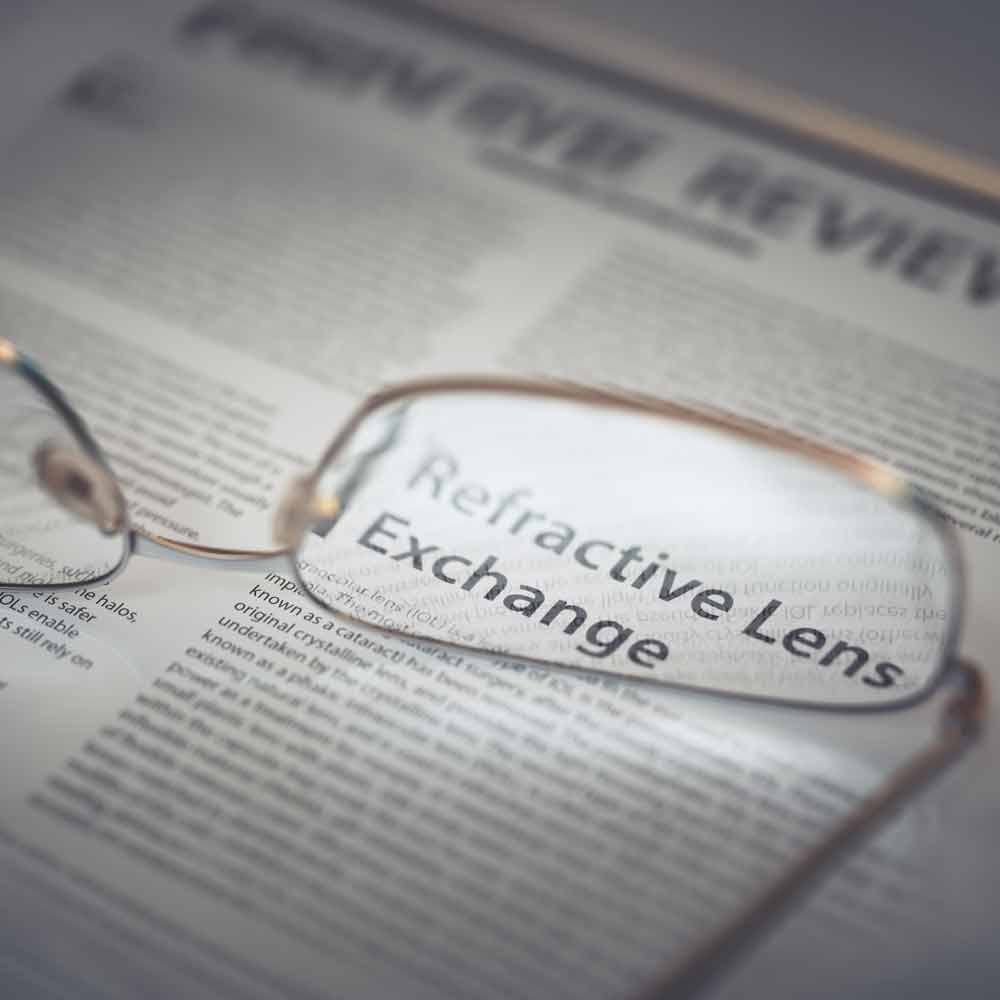 glasses laying on newspaper with RLE in focus