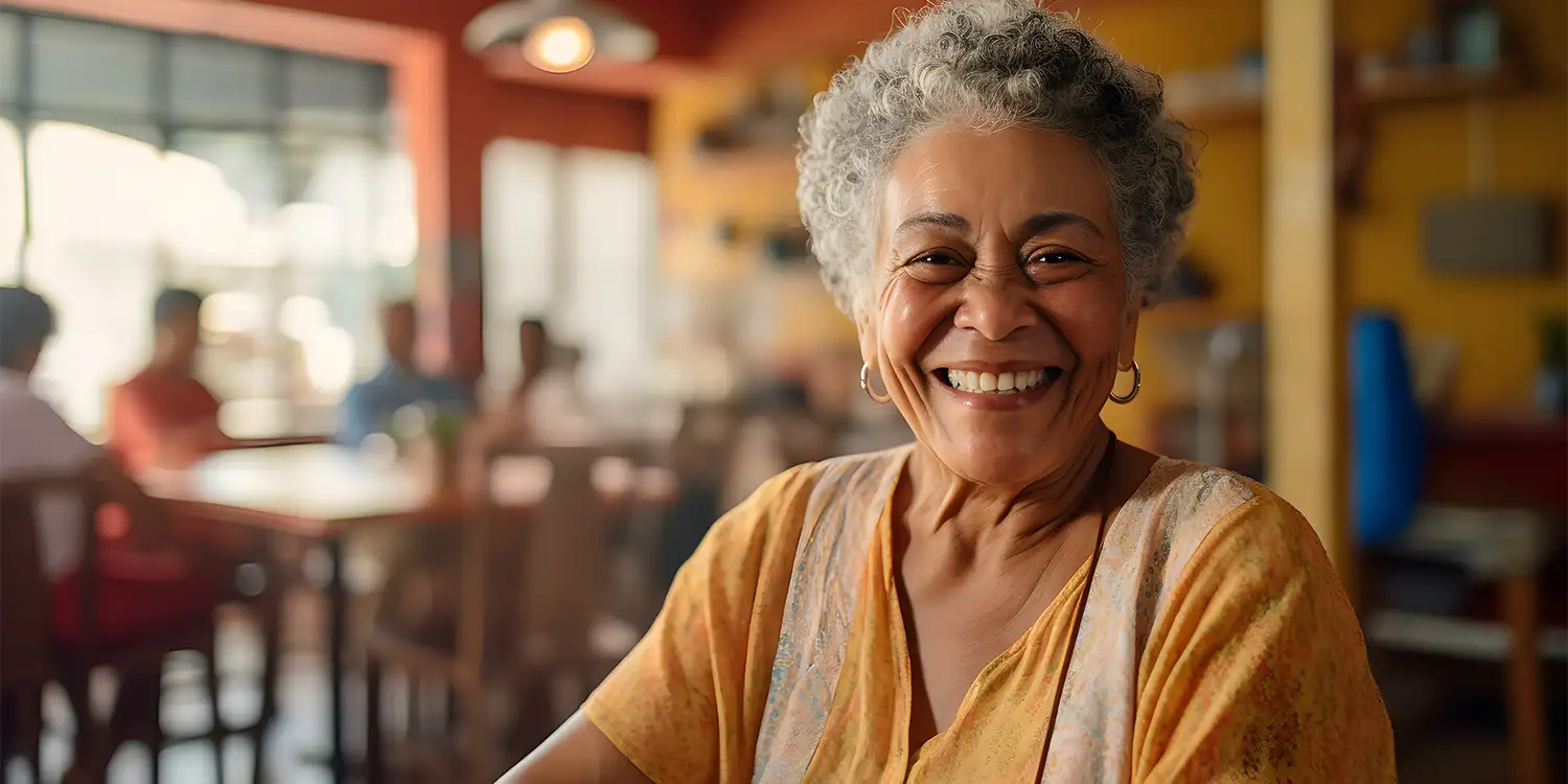 older woman smiling toward camera