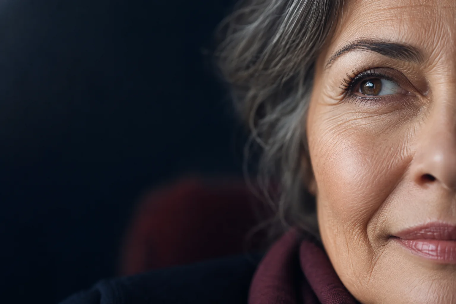 Close-up of an older adult’s brown eye and natural skin texture